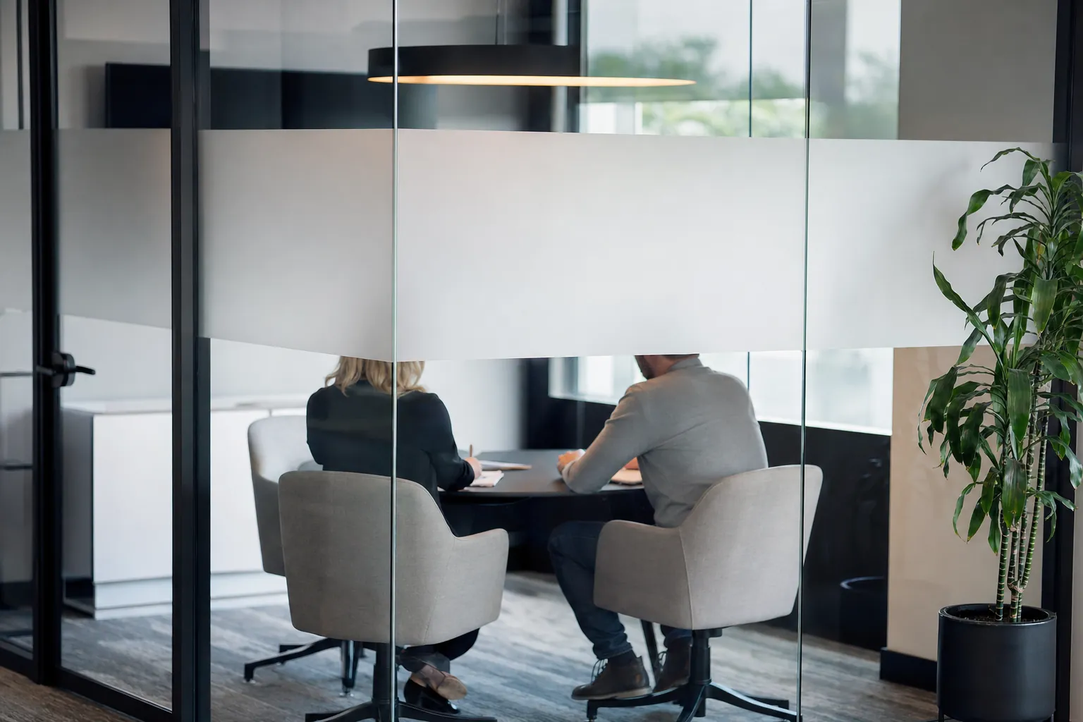 Meeting room glass with a frosted decorative film band for privacy