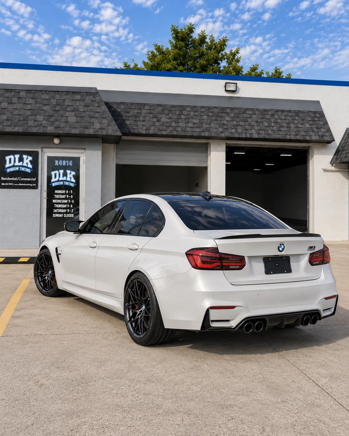 Illustration of a pearl white BMW M3 sedan with tinted windows outside DLK's Mount Clemens shop