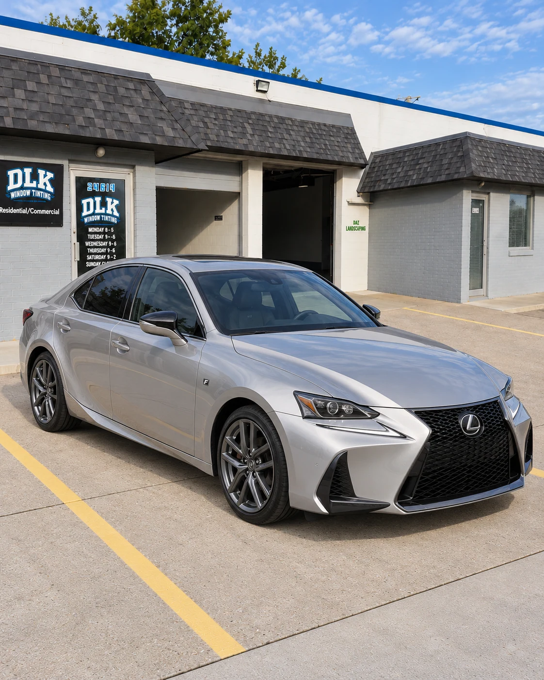 Illustration of a light silver metallic Lexus IS 350 F Sport with tinted windows outside DLK's Mount Clemens shop