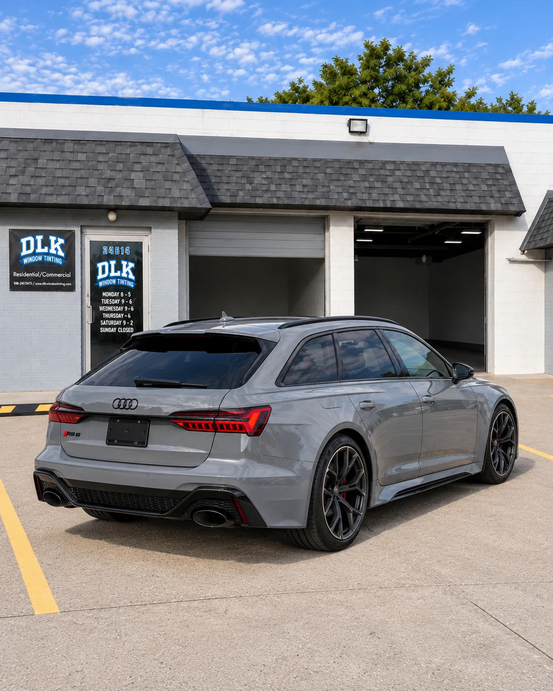 Illustration of a light nardo grey Audi RS6 Avant C8 with tinted windows outside DLK's Mount Clemens shop