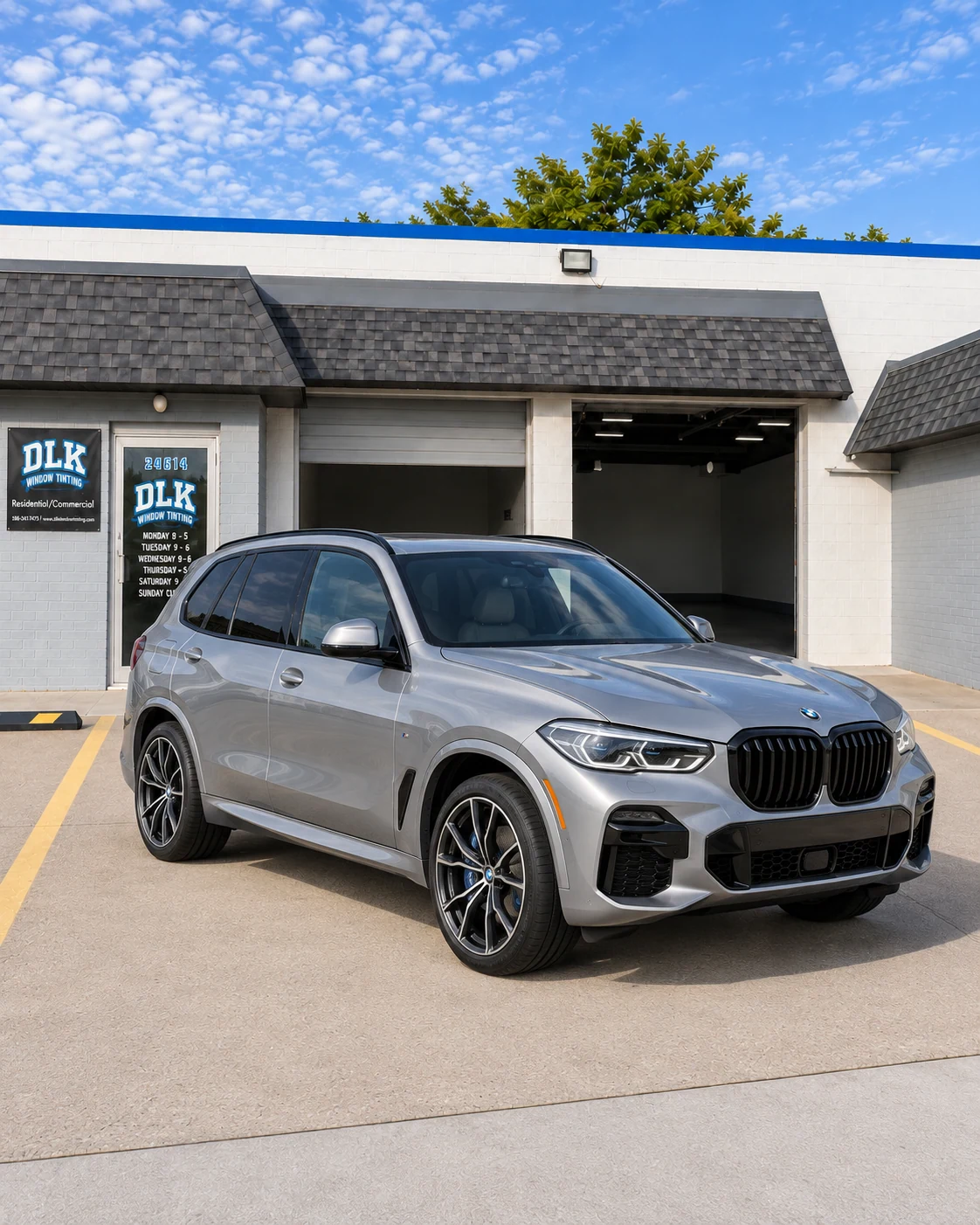 Illustration of a silver-grey metallic BMW X5 M Sport G05 with tinted windows outside DLK's Mount Clemens shop