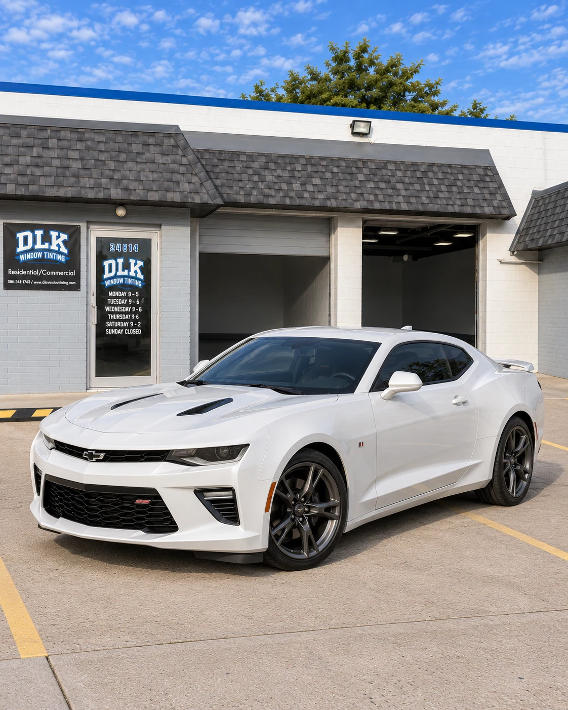 Illustration of a pearl white Chevrolet Camaro SS sixth-generation coupe with tinted windows outside DLK's Mount Clemens shop