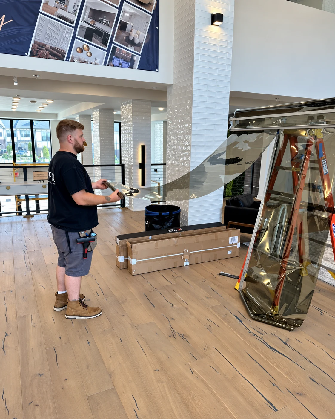 DLK installer preparing a large sheet of reflective window film