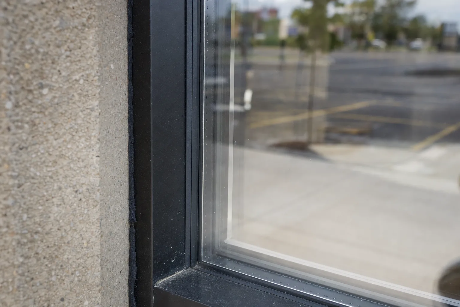 Security film and attachment strip at the edge of a storefront window