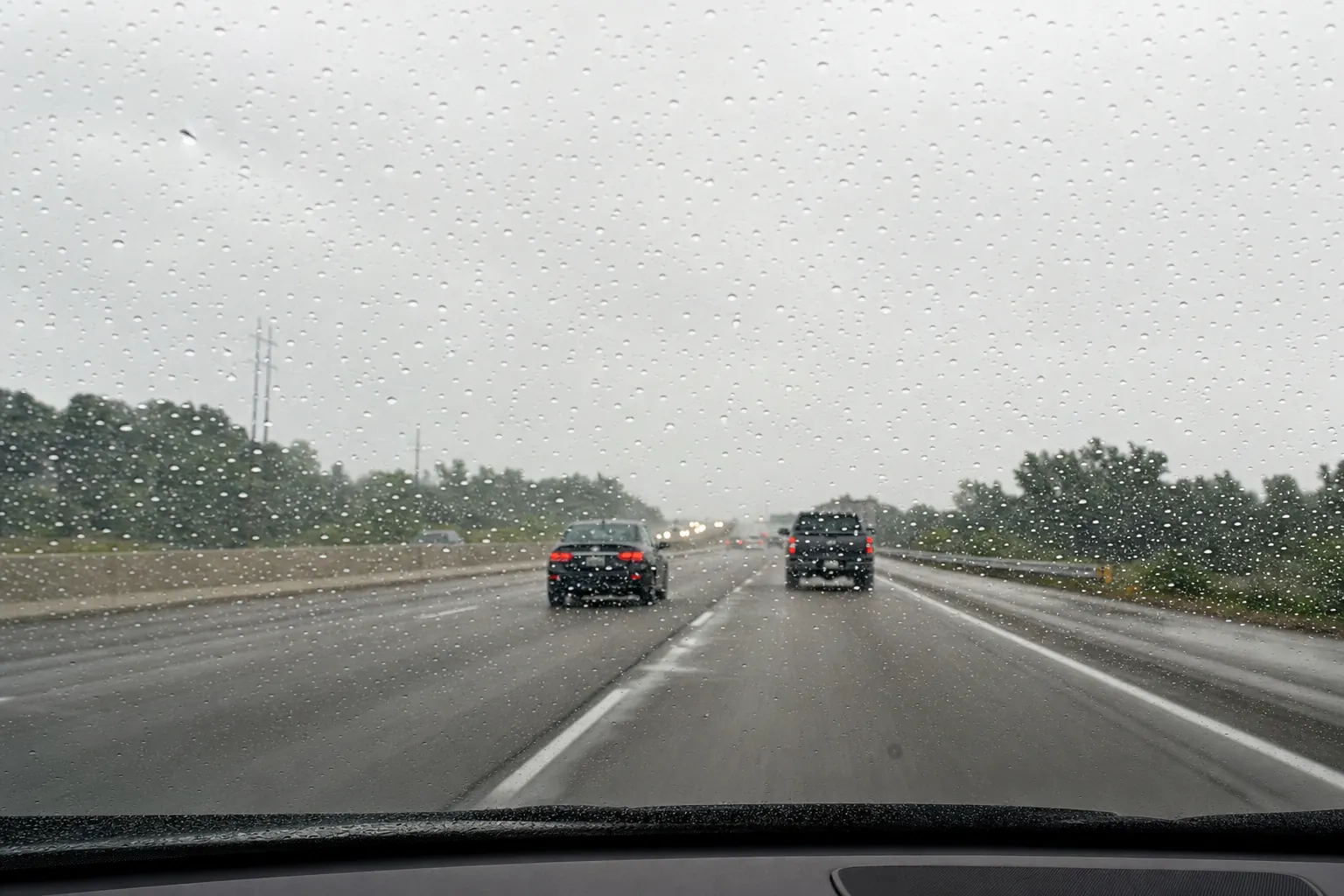 Rain beading and blowing off a coated windshield on the highway