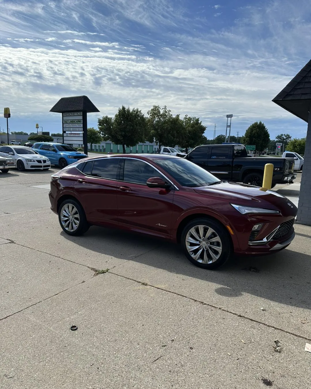 Red Buick with tinted windows in the DLK Window Tinting lot