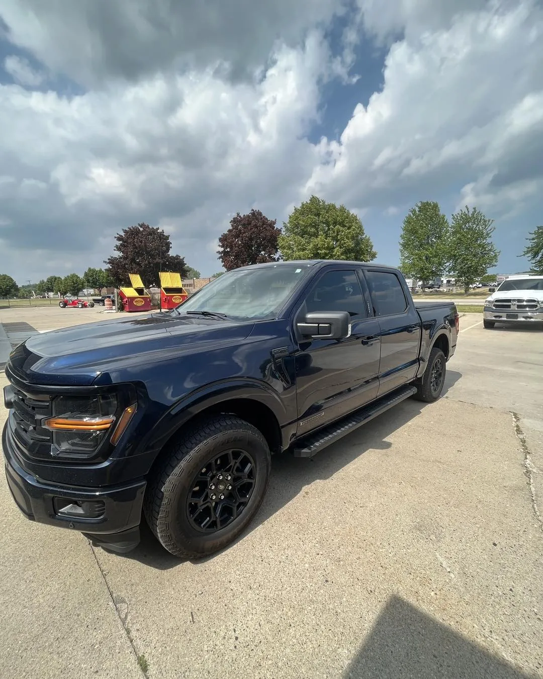 Black Ford F-150 with tinted windows outside the DLK Window Tinting shop
