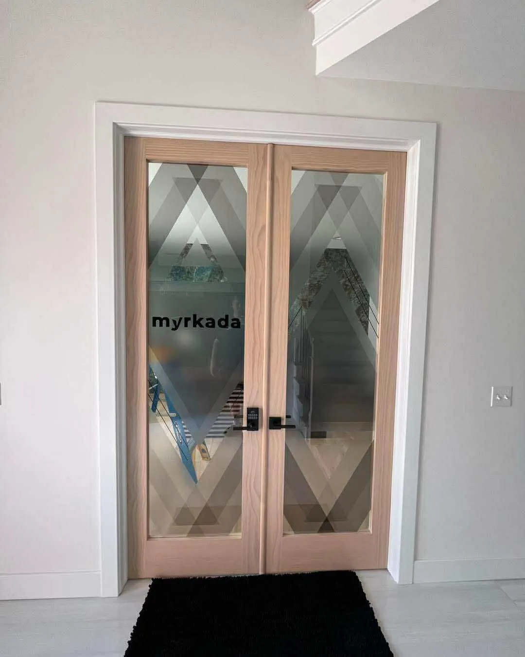 Frosted decorative film graphics on a pair of glass office doors
