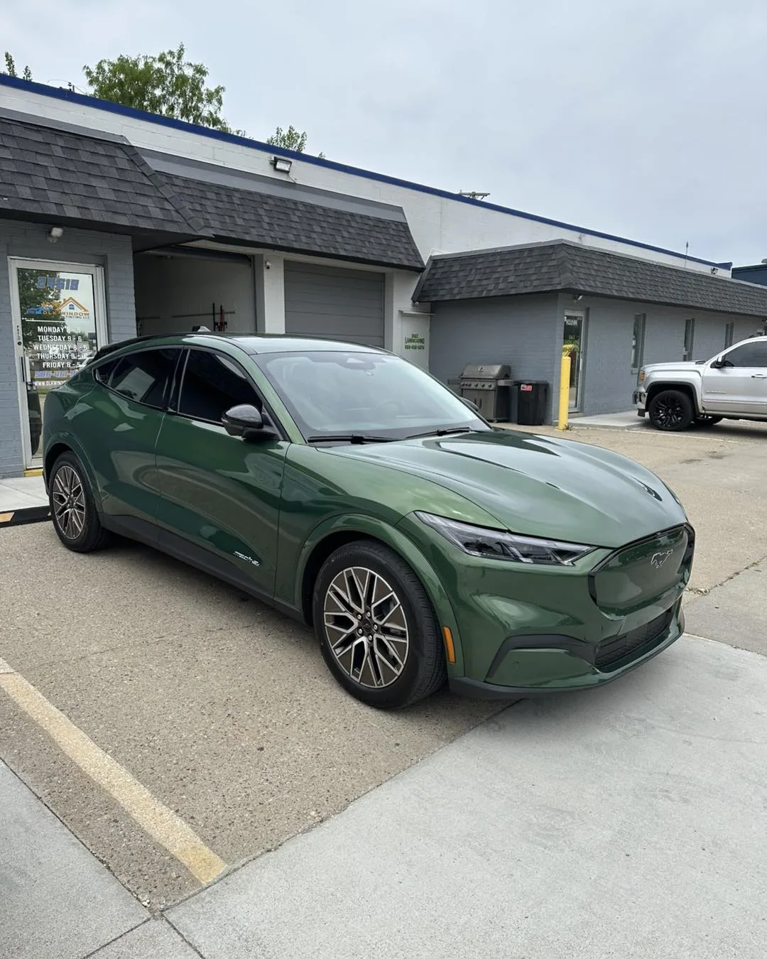 Green Ford Mustang Mach-E in front of the DLK Window Tinting shop in Mount Clemens