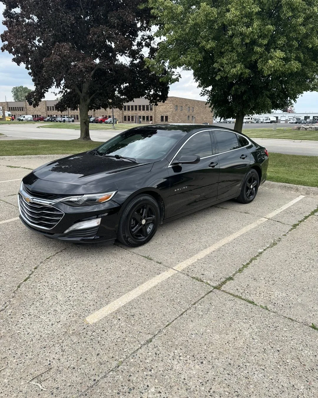 Black Chevrolet Malibu with tinted windows