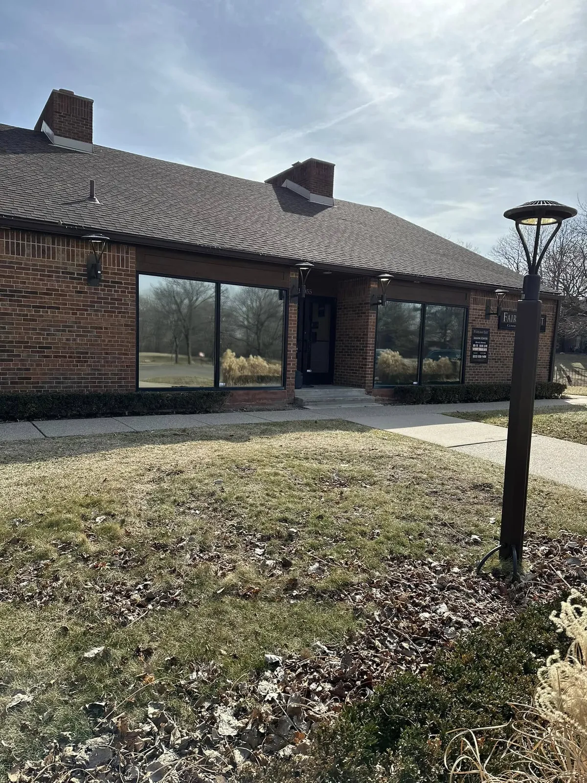 Brick office building with large windows fitted with window film