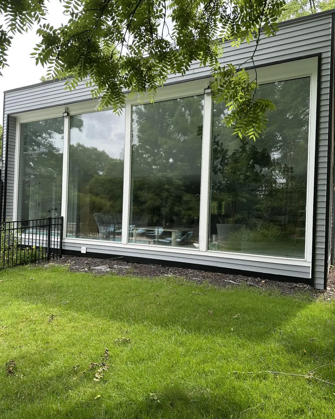 Tall picture windows fitted with flat-glass window film