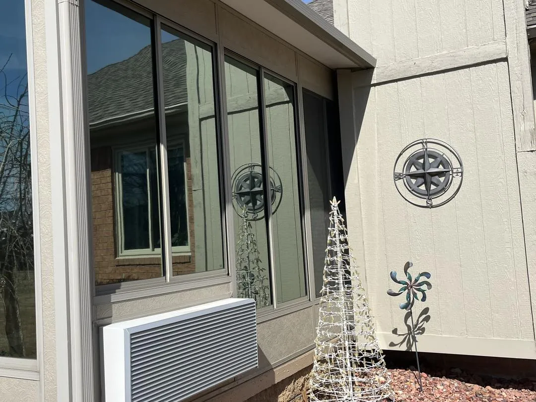 Windows on the side of a Michigan home fitted with window film